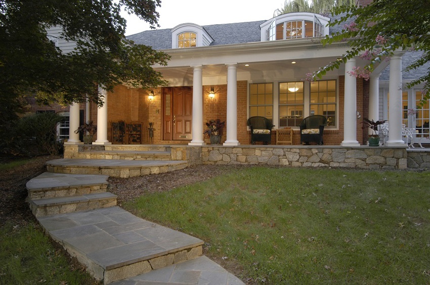 front entry porch with stone base and white pillars