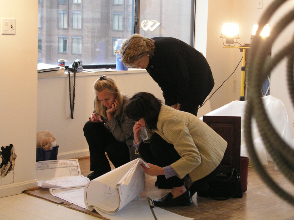 design build collaboration designers & client review renovation plans 