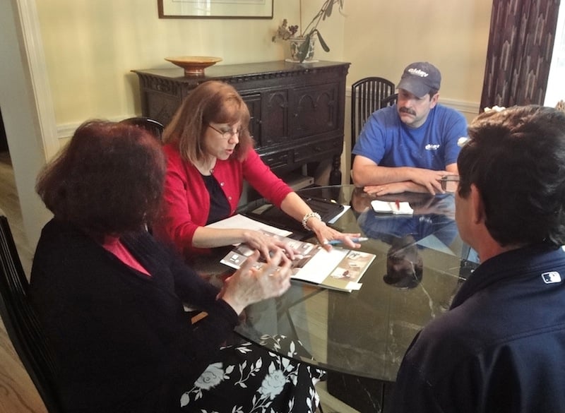 designer and carpenter meet with client for design build bath remodeling project