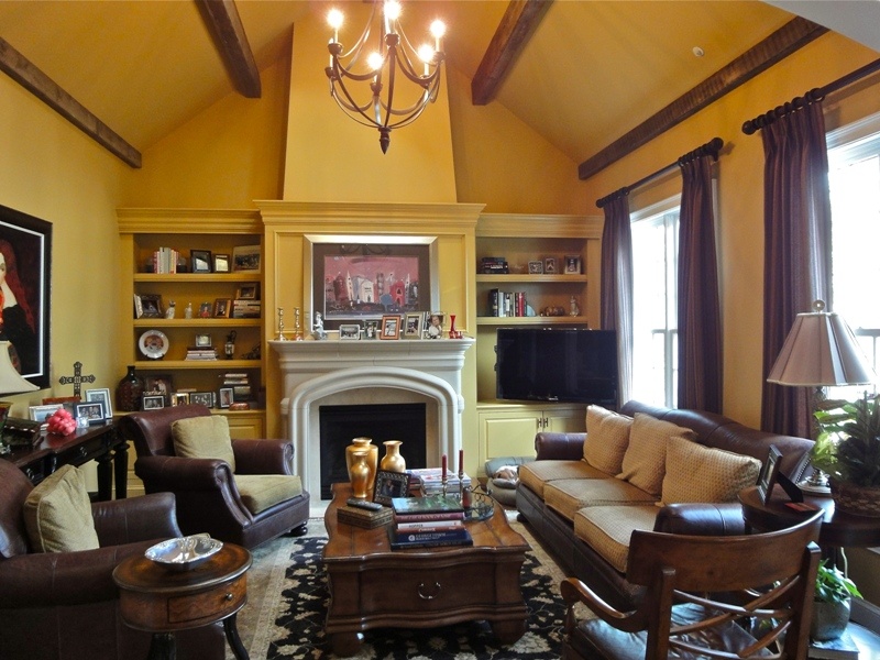 a Tuscan styled family room repeats the rustic theme of the kitchen design